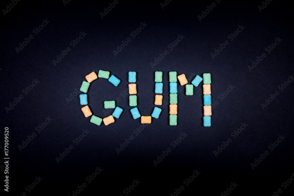 Word GUM written with chewing gum Word GUM written with chewing gum