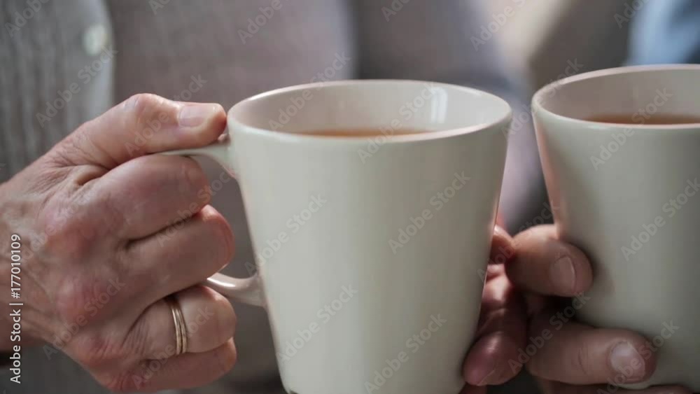 senior couple hands with cups of tea senior couple hands with cups of tea