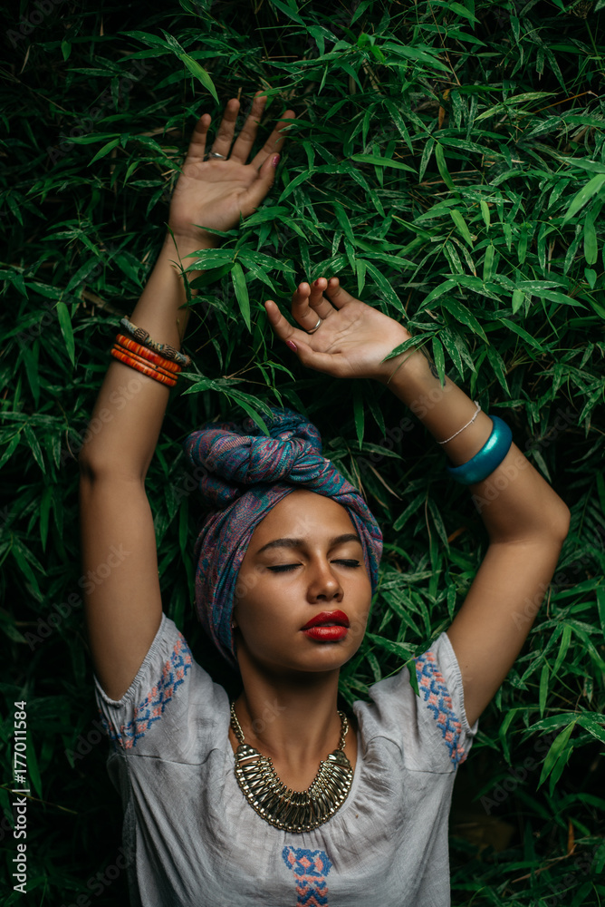 Sensual Woman With Turban Standing Against the Leafy Green Background Sensual Woman With Turban Standing Against the Leafy Green Background