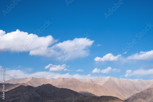 Closeup image of mountains and blue sky with clouds background in Ladakh , India