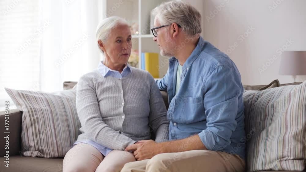 sad senior couple hugging at home sad senior couple hugging at home