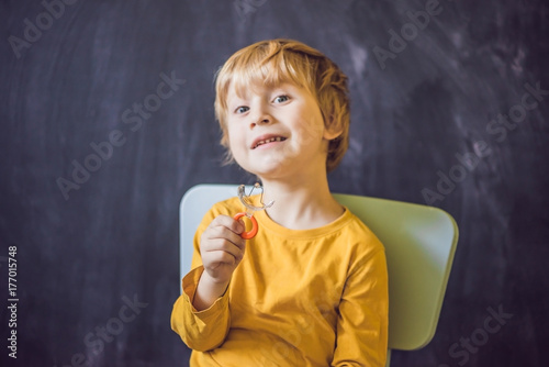 Three-year old boy shows vestibular plate. Plate with a bead to stimulate the tongue. dysarthria, rhinolalia photo