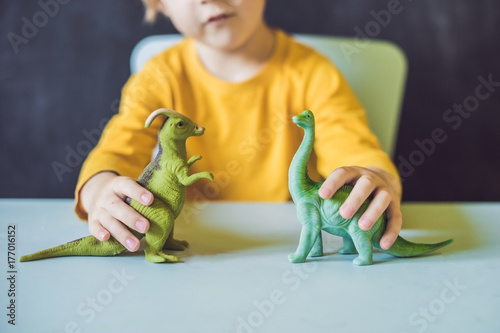 Boy showing a dinosaur as a paleontologist photo