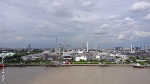 Cargo Boats and Refinery along Chapraya River at Banchark Refinery in Thailand
 photo