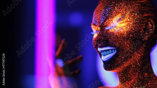 Girl laughing in the ultraviolet light photo