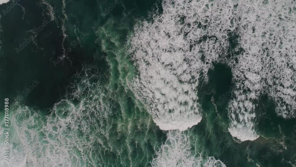 Waves breaking shot from above