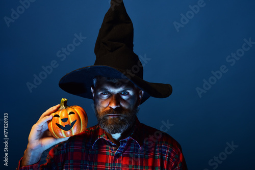 Halloween wizard hipster with beard and jack o lantern