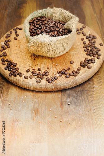 Coffee beans and sack bag on old background