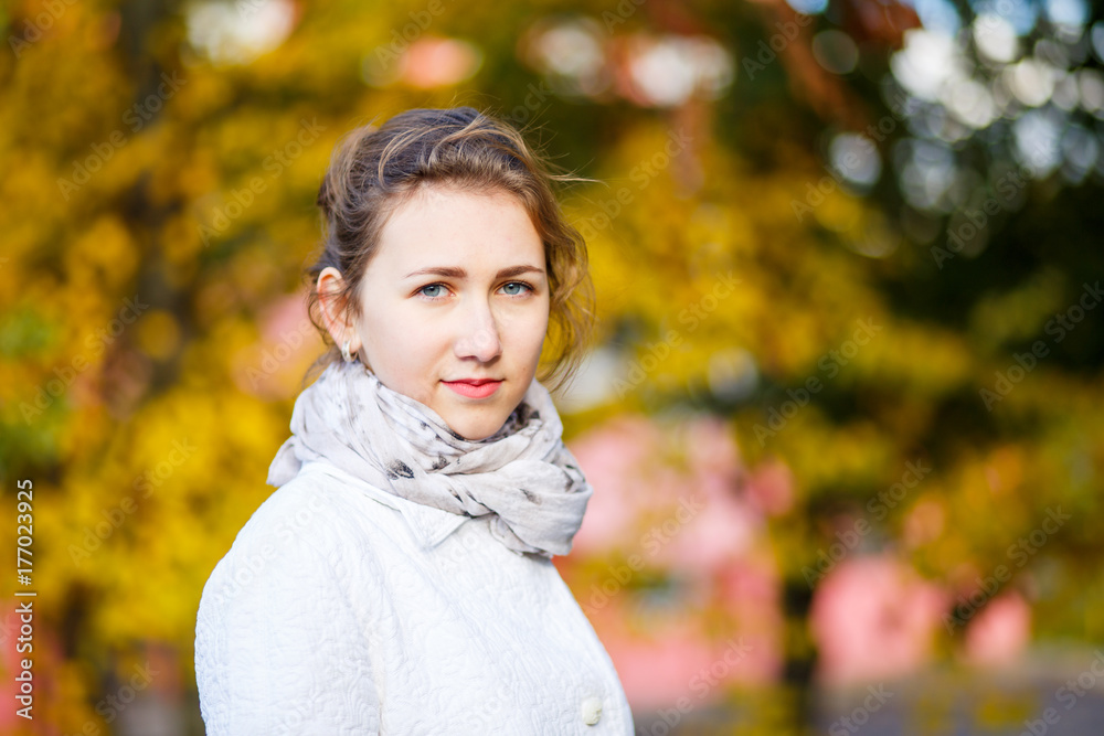 Young smiling teenage girl standing in autumn park Young smiling teenage girl standing in autumn park