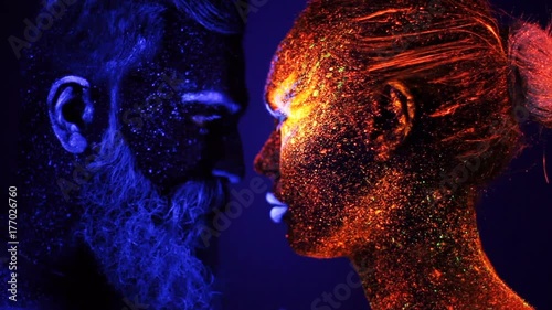 Portrait of a bearded man and woman painted in ultraviolet powder photo