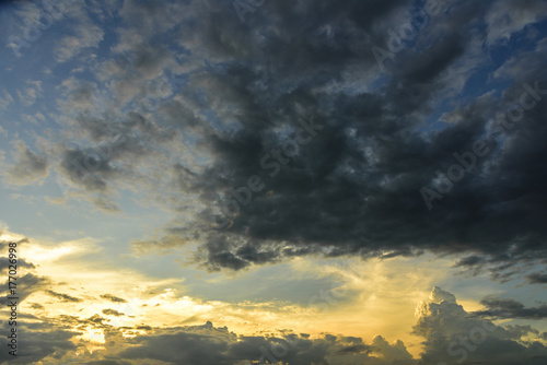 Cloudy sky group with condensation in evening before sunset and raining.