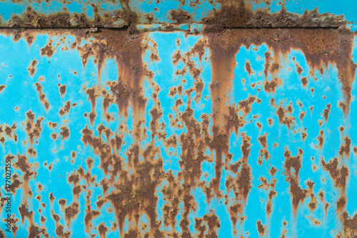 colorful aqua blue metal surface covered in rust