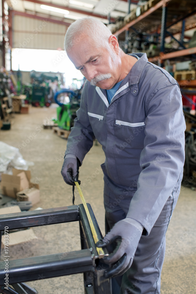 senior worker at a plastic door and window factory