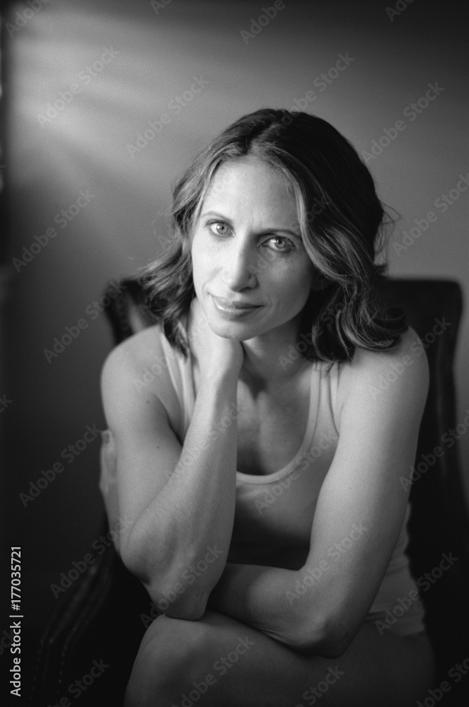Black and white portrait of a beautiful woman sitting in a chair Black and white portrait of a beautiful woman sitting in a chair