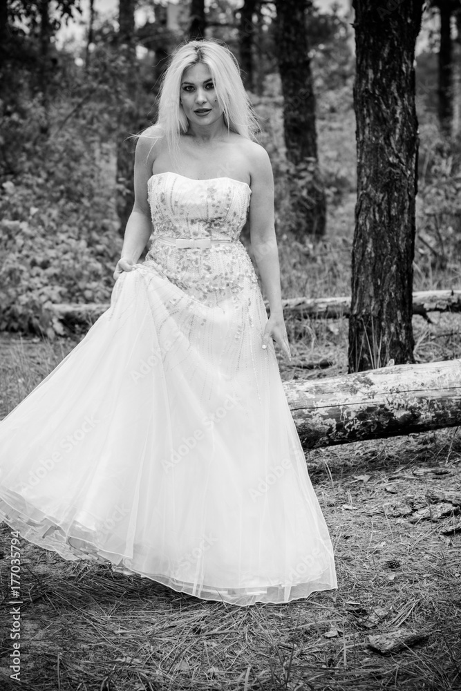 Romantic tender bride in a white dress in the forest. The concept of a wedding in a rustic style. Beauty of the bride in combination with forest and nature, wedding fashion and dress elements Romantic tender bride in a white dress in the forest. The concept of a wedding in a rustic style. Beauty of the bride in combination with forest and nature, wedding fashion and dress elements