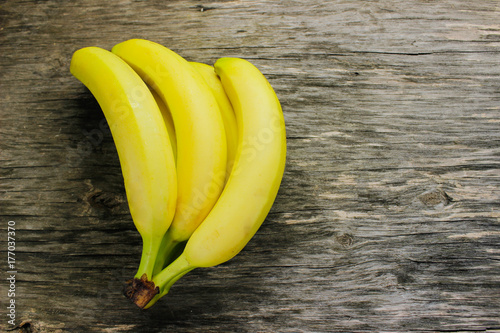 Sweet bananas on a gray wooden table.