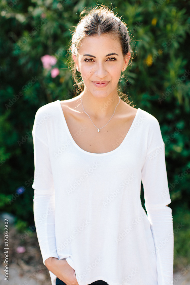 A young mixed ethnic woman in stylish clothes, posing outdoors A young mixed ethnic woman in stylish clothes, posing outdoors