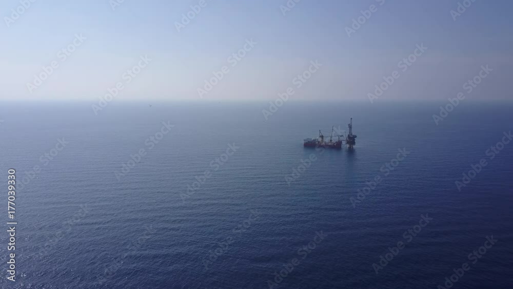An aerial view from a drone of a tender drilling oil rig (Barge Oil Rig) on the production platform on sunny day
An aerial view from a drone of a tender drilling oil rig (Barge Oil Rig) on the production platform on sunny day