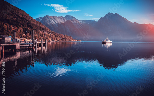 Fjord with ferry, sunrise in Norway