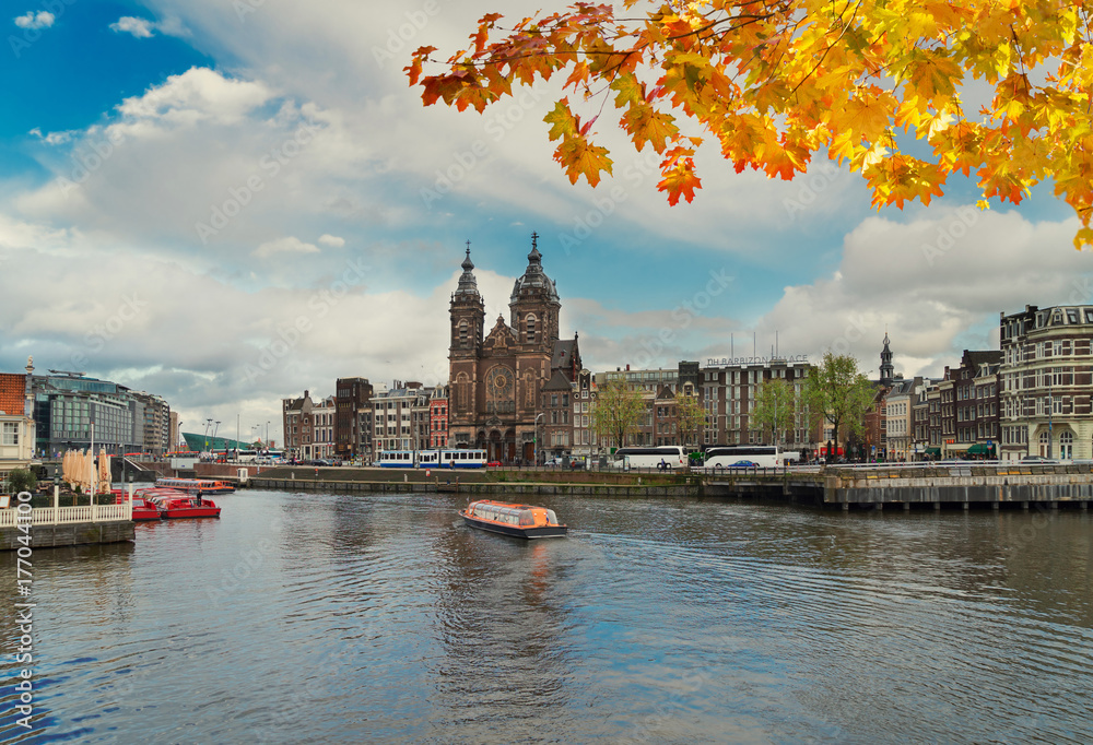Amsterdam skyline with Church of St Nicholas over old town canal, Amsterdam, Holland at autumn day