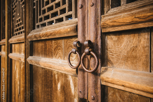 The knocker on the wooden door