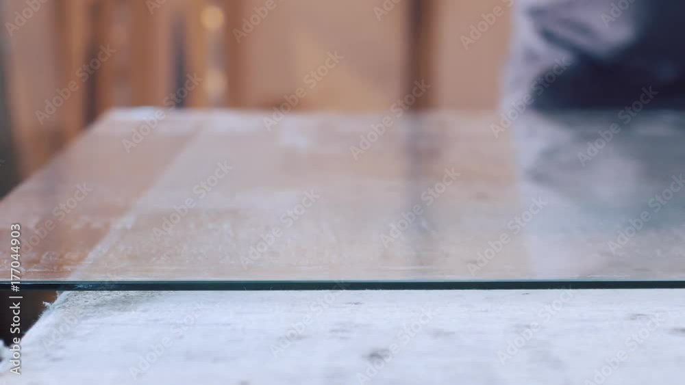 man cutting glass with glass cutter man cutting glass with glass cutter