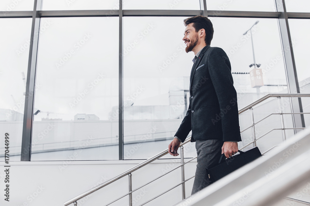 Young men coming down the stairs in a modern building Young men coming down the stairs in a modern building