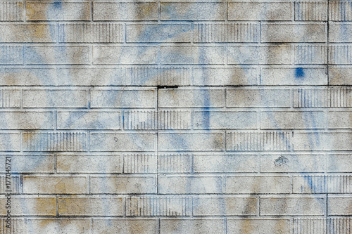 White spray paint covering graffiti markings on building wall