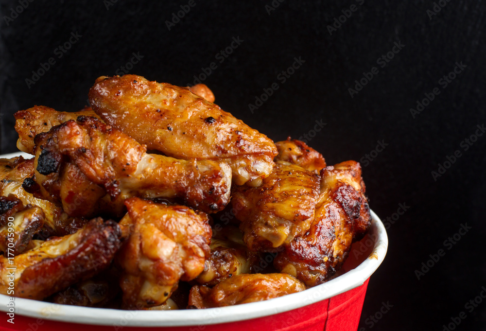 Chicken legs in a bucket.