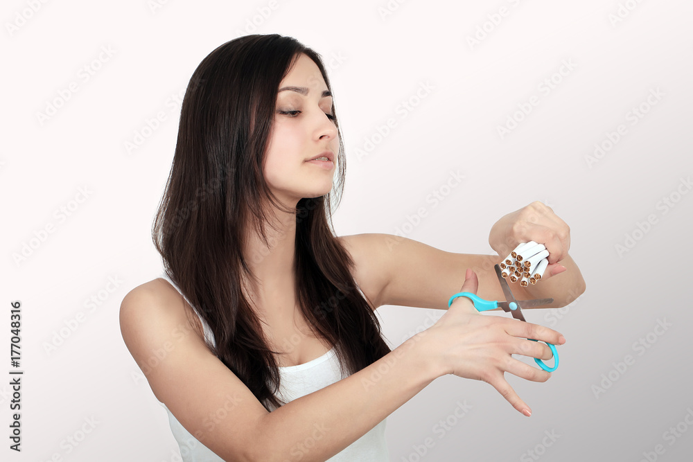 Quit Smoking. Closeup Of Beautiful Happy Female Breaking Cigarette. Portrait Of Smiling Woman Holding Broken Cigarette In Hands. Healthy Lifestyle Concept. High Resolution Quit Smoking. Closeup Of Beautiful Happy Female Breaking Cigarette. Portrait Of Smiling Woman Holding Broken Cigarette In Hands. Healthy Lifestyle Concept. High Resolution
