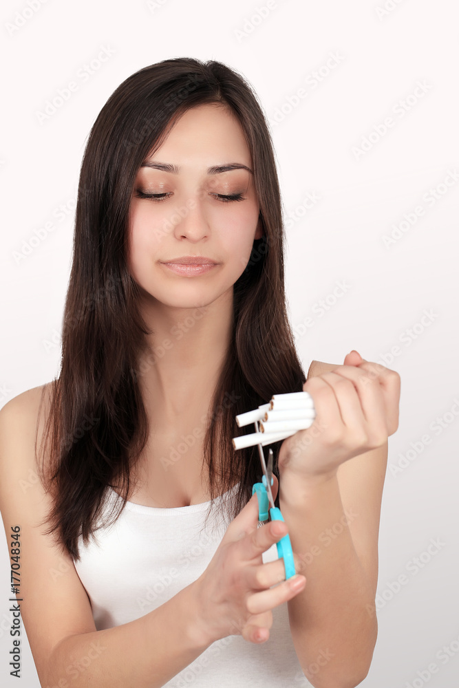 Bad Habit. Portrait Of Beautiful Young Woman And Cutting It With Scissors. Closeup Of Female Quitting Smoking Cigarettes. Quit Smoking Concept. High Resolution Bad Habit. Portrait Of Beautiful Young Woman And Cutting It With Scissors. Closeup Of Female Quitting Smoking Cigarettes. Quit Smoking Concept. High Resolution