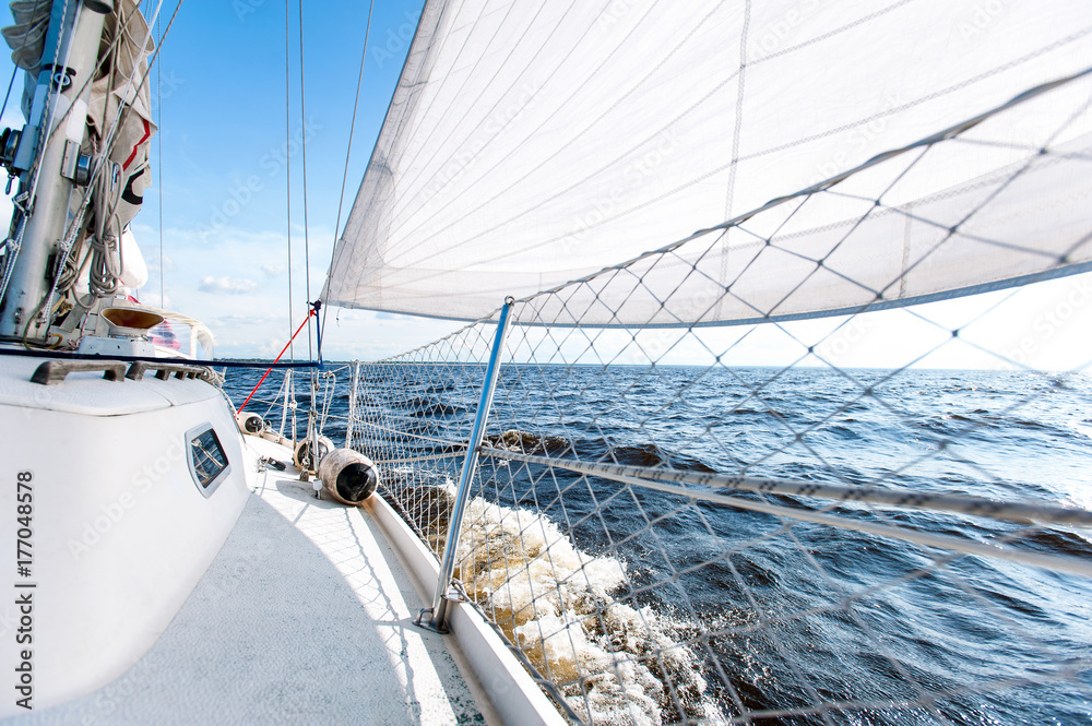 Sailing fast on port tacks with water splashing on deck Sailing fast on port tacks with water splashing on deck