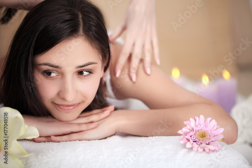 Spa Treatment. Beautiful Woman Getting Stones Massage in Spa Salon.
