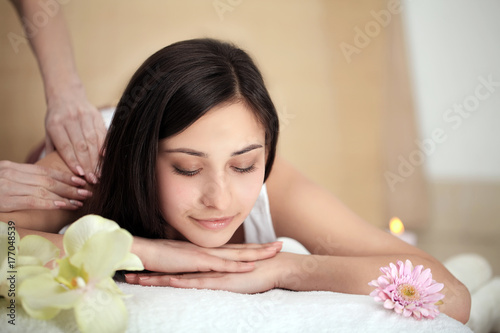 Spa Treatment. Beautiful Woman Getting Stones Massage in Spa Salon.