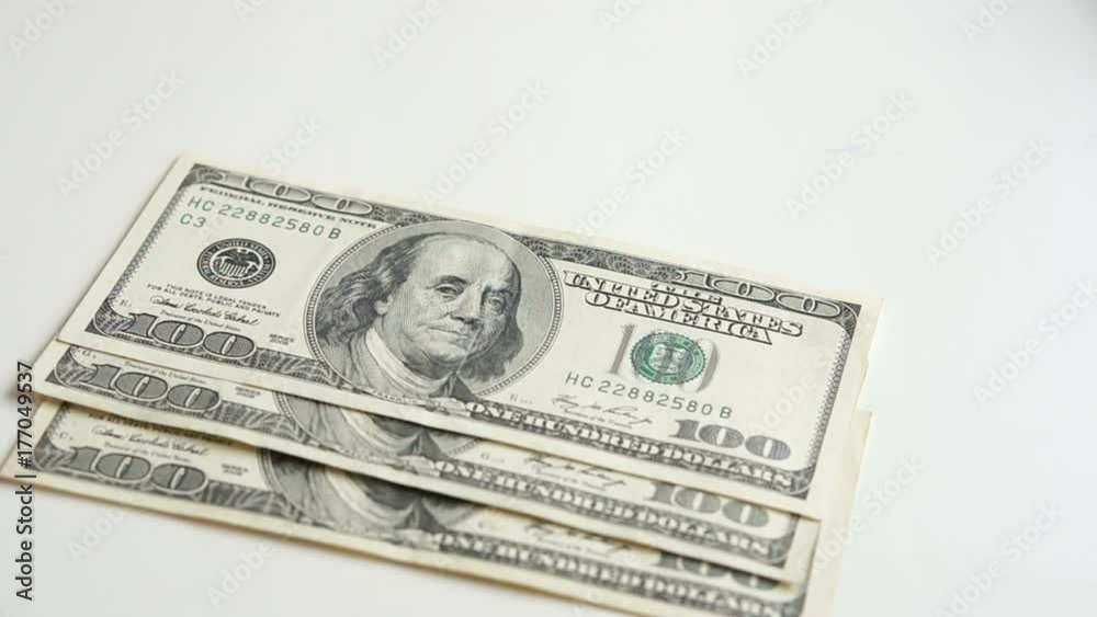 The hand counting of the one hundred dollar bills The hand counting of the one hundred dollar bills