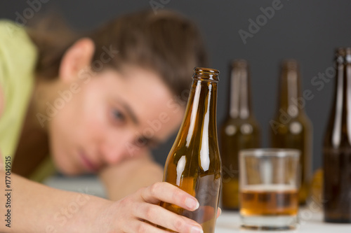 girl in depression drinking alcohol in solitude