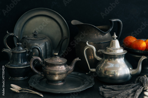 A set of pewter plates, platters, and pots.