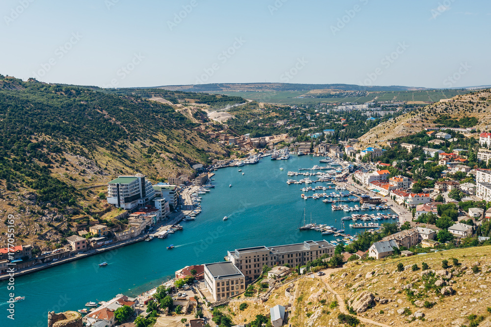 Beautiful aerial view of the Black Sea coast and the city Balaklava in clear sunny summer day. Balaklava Bay, Crimea Beautiful aerial view of the Black Sea coast and the city Balaklava in clear sunny summer day. Balaklava Bay, Crimea