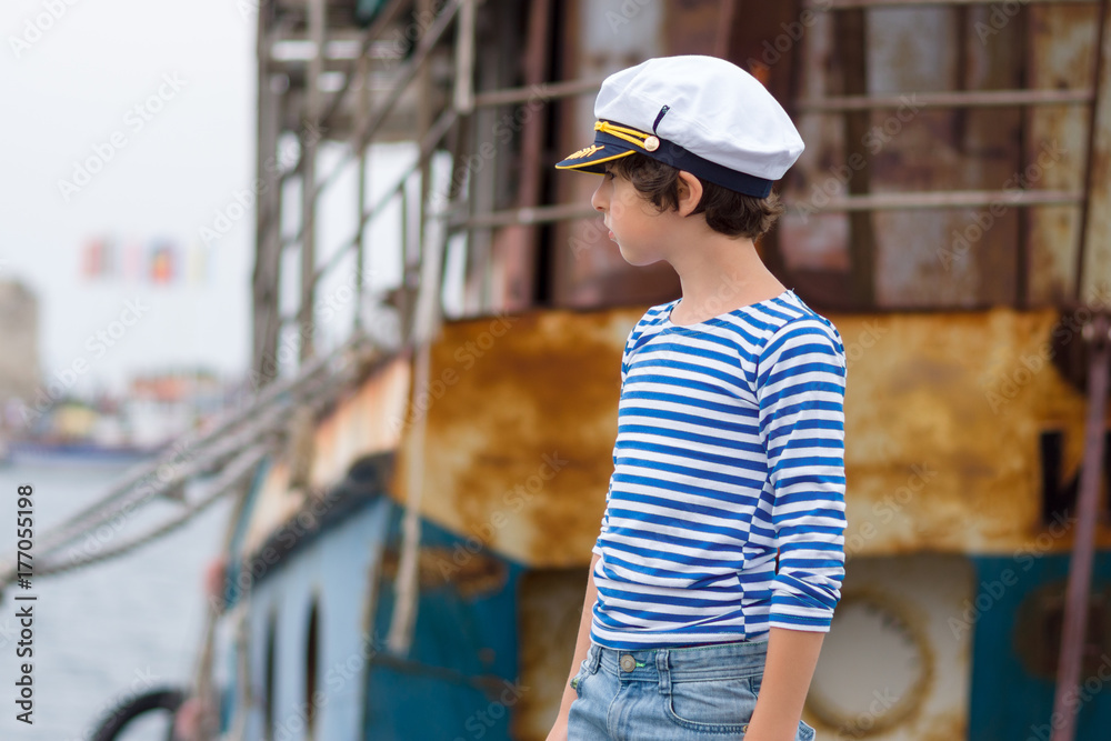 Portrait of a boy in a striped long sleeve T-Shirt (Telnyashka) and captain's cap. Portrait of a boy in a striped long sleeve T-Shirt (Telnyashka) and captain's cap.