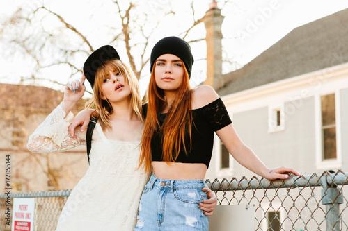 Two pretty girl standing outside photo