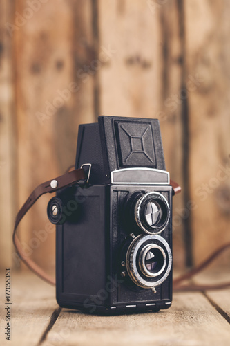 Old film camera on wooden table