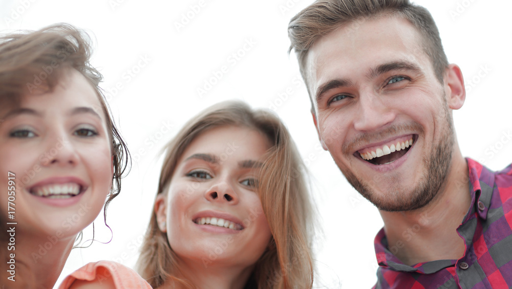 closeup of three young people smiling on white background