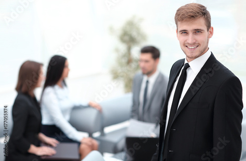 portrait of confident businessman on background of office.