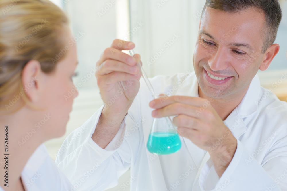 Male technician with glass flask Male technician with glass flask