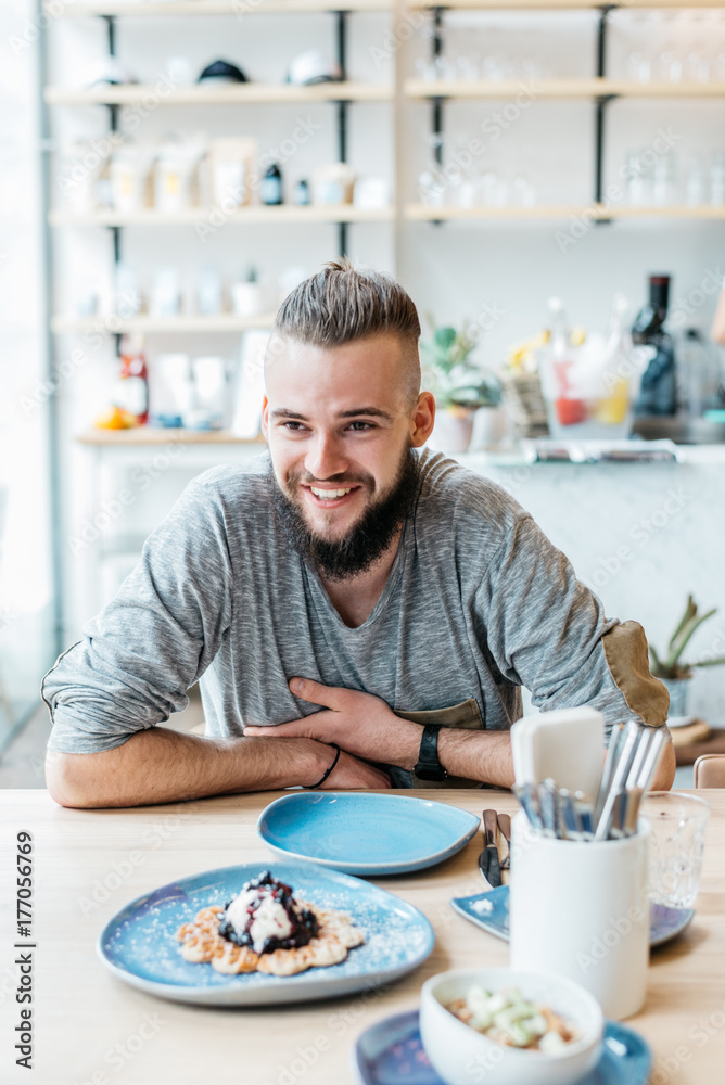 Young man sitting at the restaurant Young man sitting at the restaurant