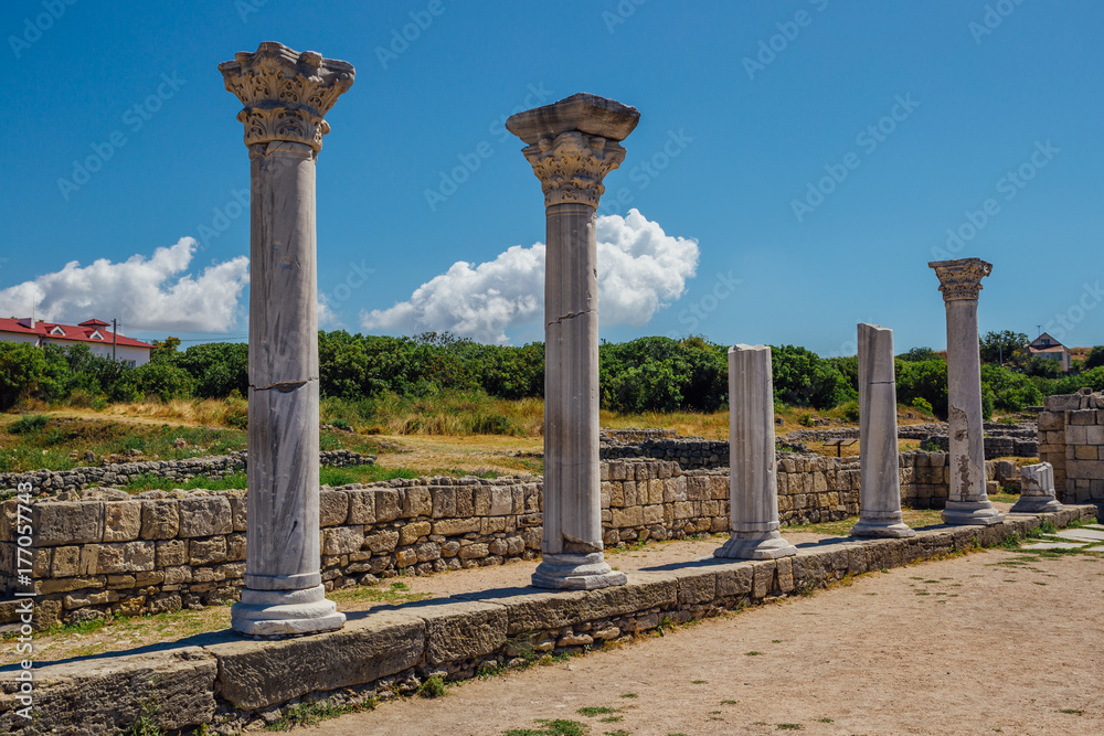 Old Greek columns remains of ancient Byzantian basilica. Old ruins in archaeological park Chersonesus