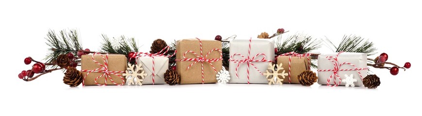 Christmas border with branches and rustic brown and white gift boxes isolated on a white background