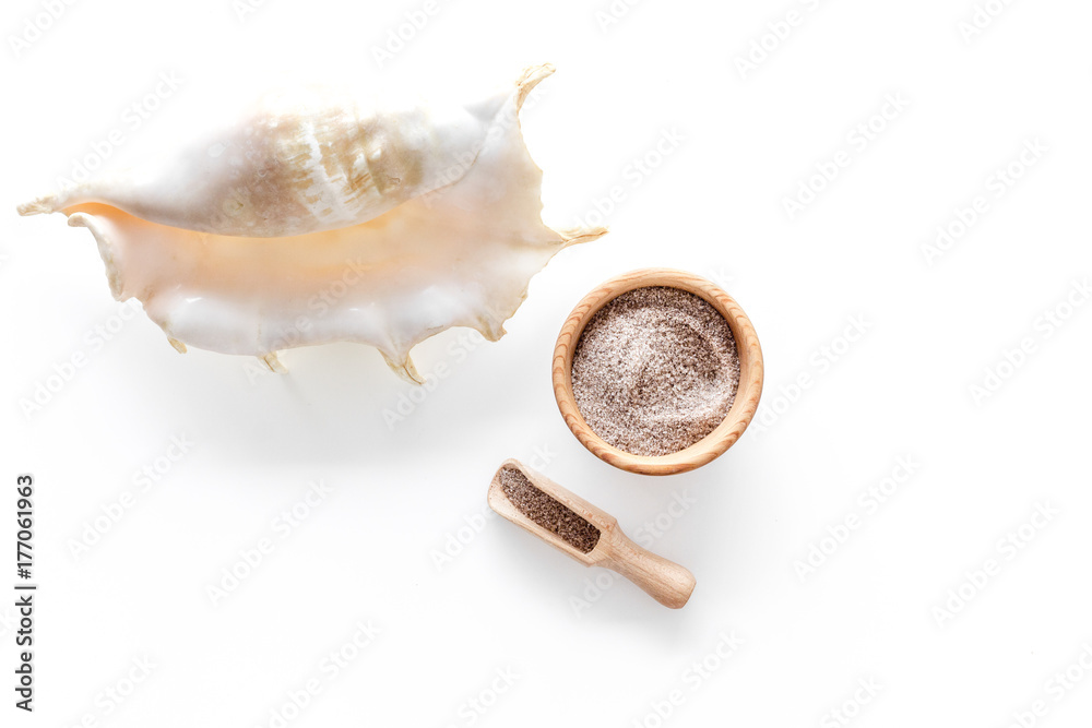 Sea salt from dead sea and shell in cosmetics set for spa on white background top view copyspace Sea salt from dead sea and shell in cosmetics set for spa on white background top view copyspace