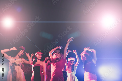 new year party, holidays, celebration, nightlife and people concept - Young people having fun dancing at a party.