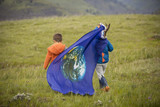 kids holding earth flag